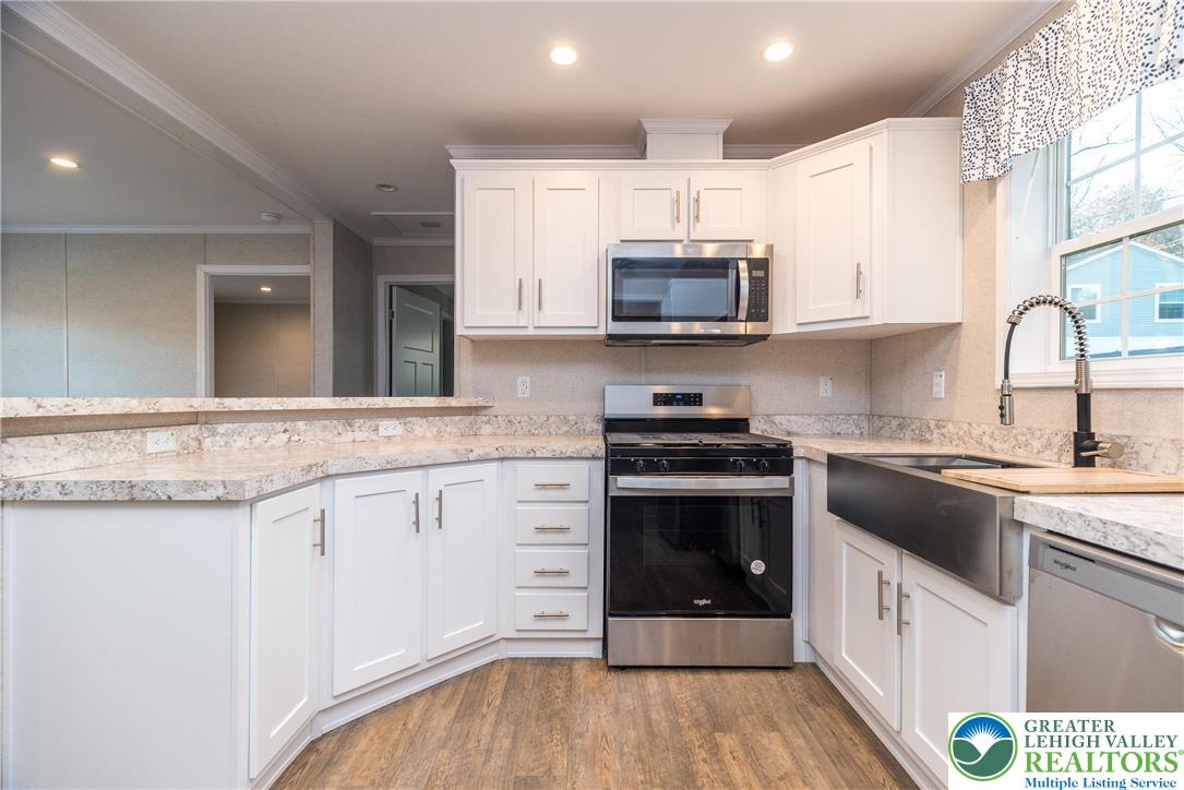 465 Royal Manor Road, Unit LOT 5 Easton, PA 18042 - Photo 5 of 24 a kitchen with stainless steel appliances white cabinets a sink and a stove