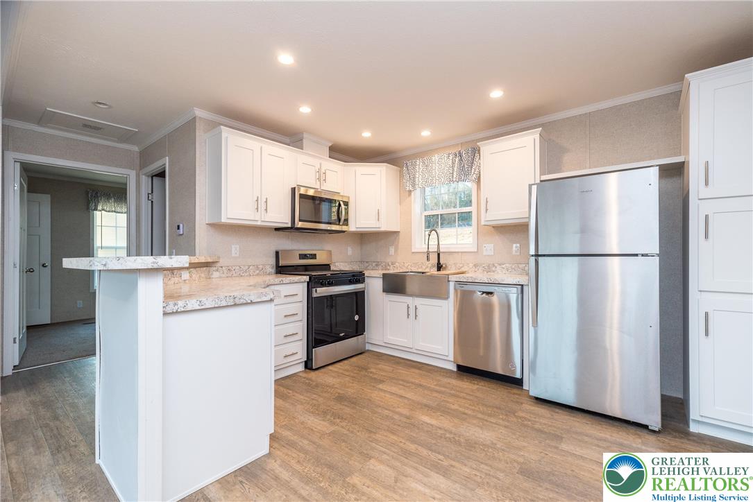 465 Royal Manor Road, Unit LOT 5 Easton, PA 18042 - Photo 6 of 24 a kitchen with a refrigerator a stove top oven a sink and dishwasher