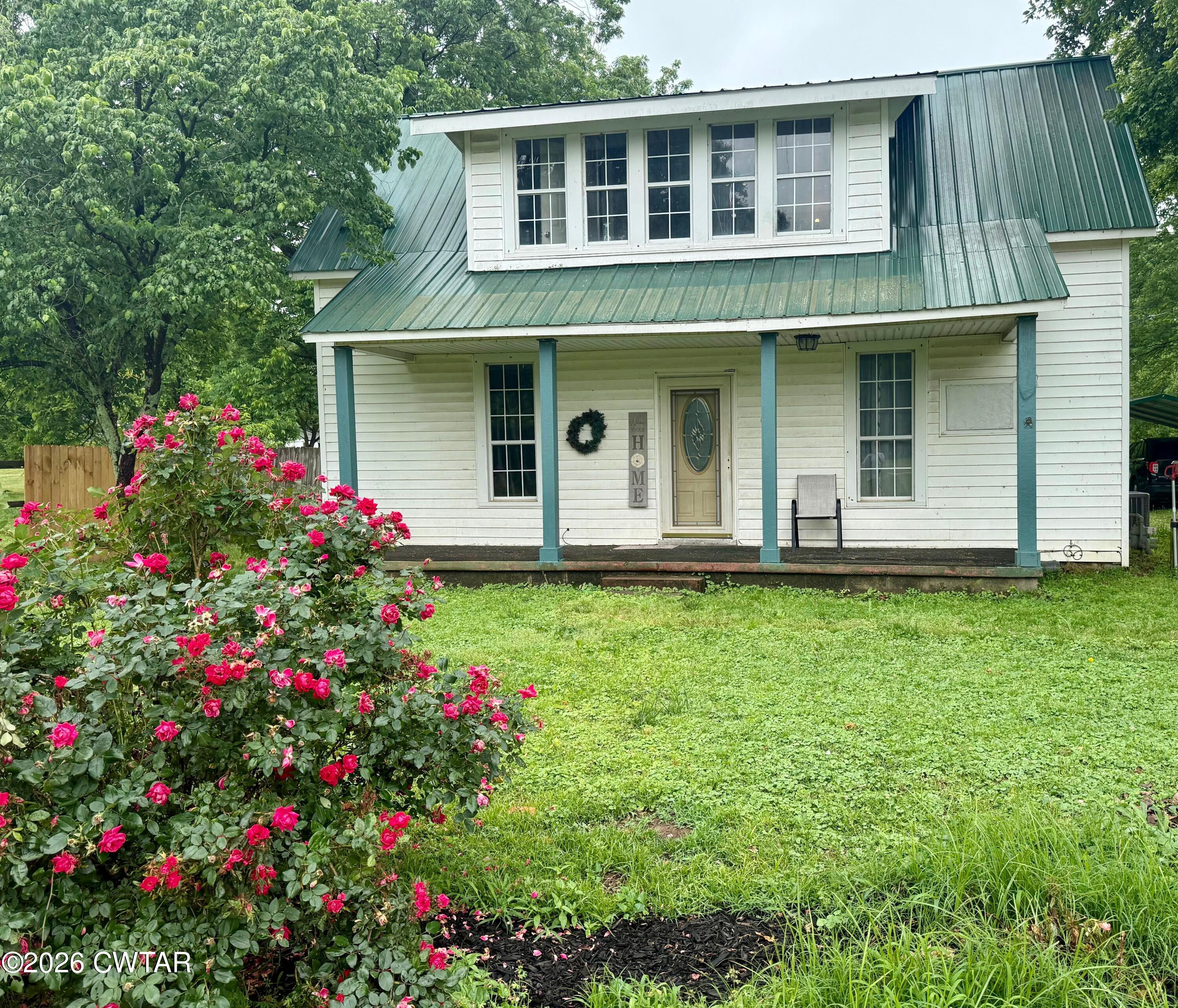 1935 Buster Collins Road Kenton, TN 38233 - Photo 1 of 18 a front view of a house with fountain