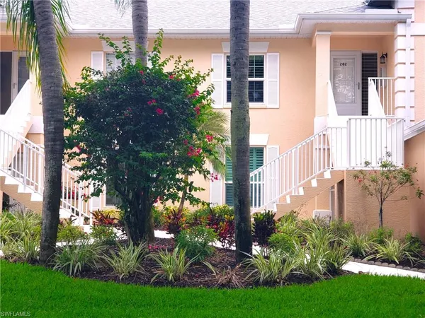 a view of a multi story building with a yard