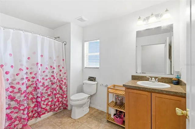 a living room with furniture a ceiling fan and a window