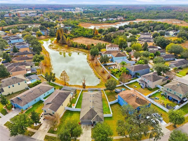 an aerial view of residential houses with outdoor space