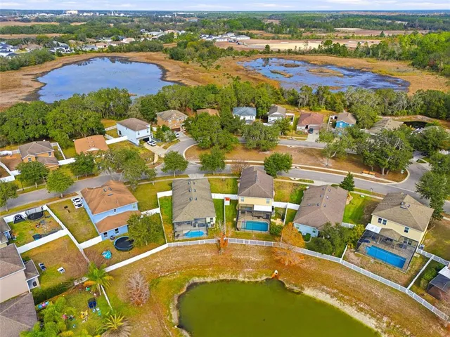 an aerial view of residential houses with outdoor space and river view
