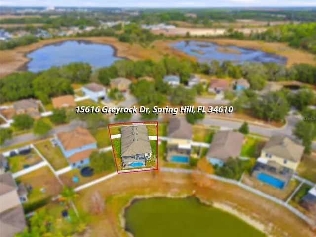 an aerial view of residential house with an outdoor space and seating
