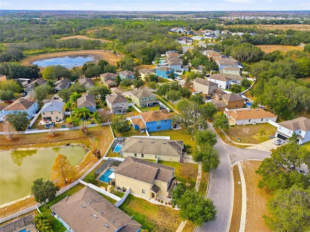 an aerial view of residential houses with outdoor space