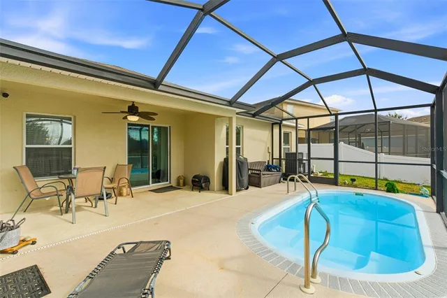 a room with pool table and glass windows