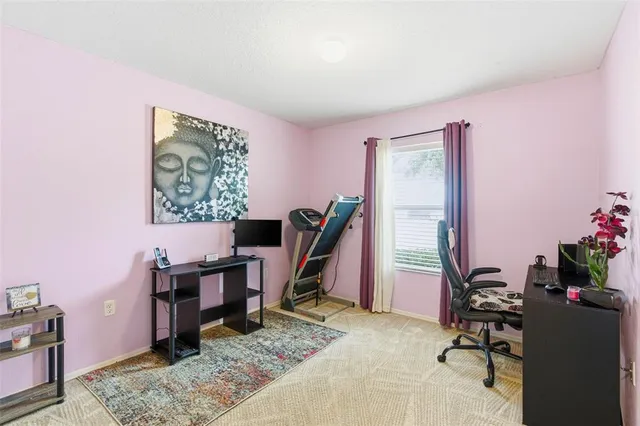a view of a hallway to a livingroom with furniture