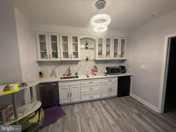 a kitchen with stainless steel appliances granite countertop a sink and cabinets