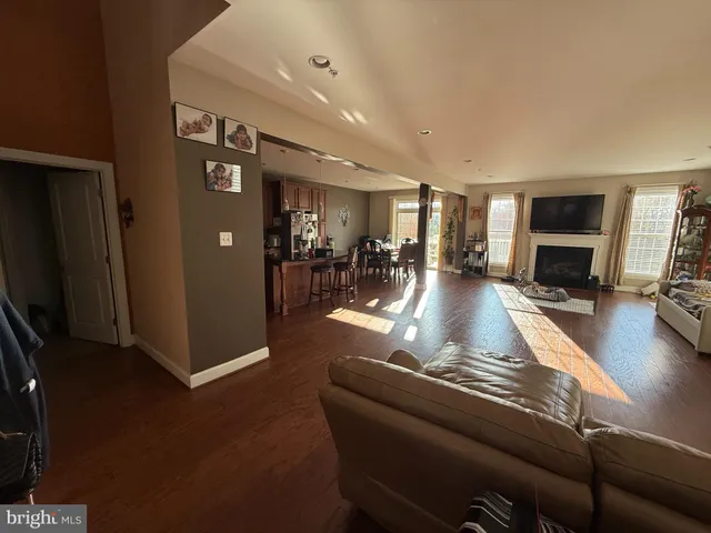 a living room with furniture a dining table and a flat screen tv