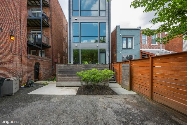 a view of a house with a yard and potted plants