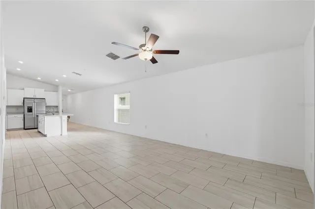 a view of a livingroom with a ceiling fan and window