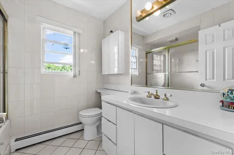 a bathroom with a sink toilet and a mirror