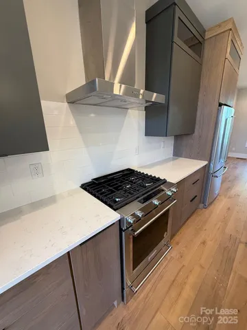 a stove top oven sitting inside of a kitchen