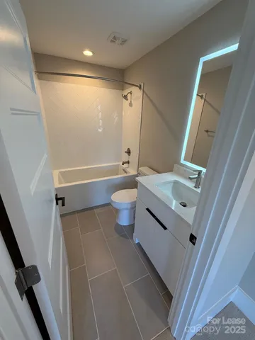 a bathroom with a sink a toilet and a shower