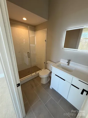 a bathroom with a double vanity sink toilet and shower