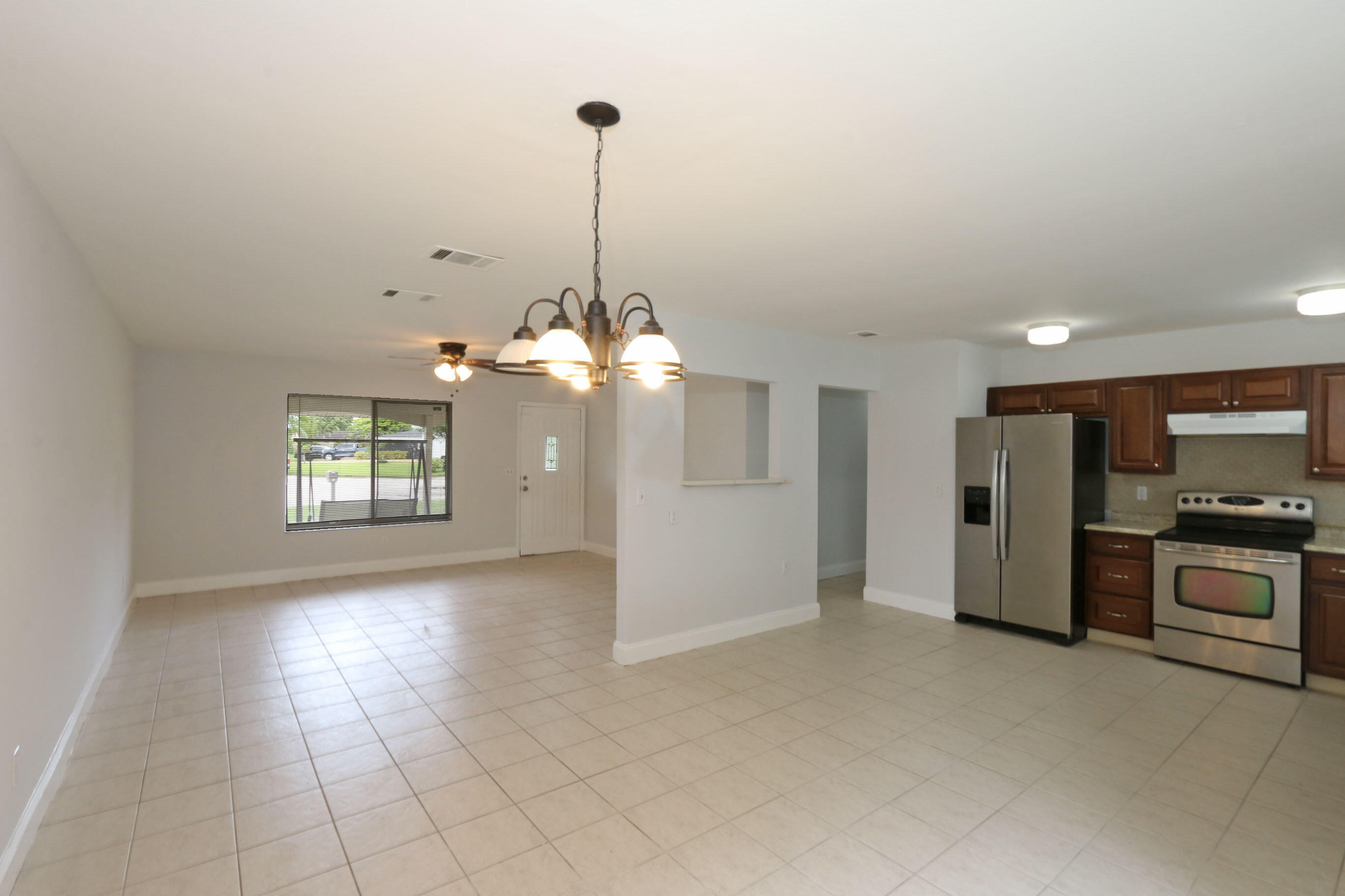 400 Southwest Ruffner Court Port St. Lucie, FL 34953 - Photo 11 of 27 Kitchen, Living Room, Dining Room
