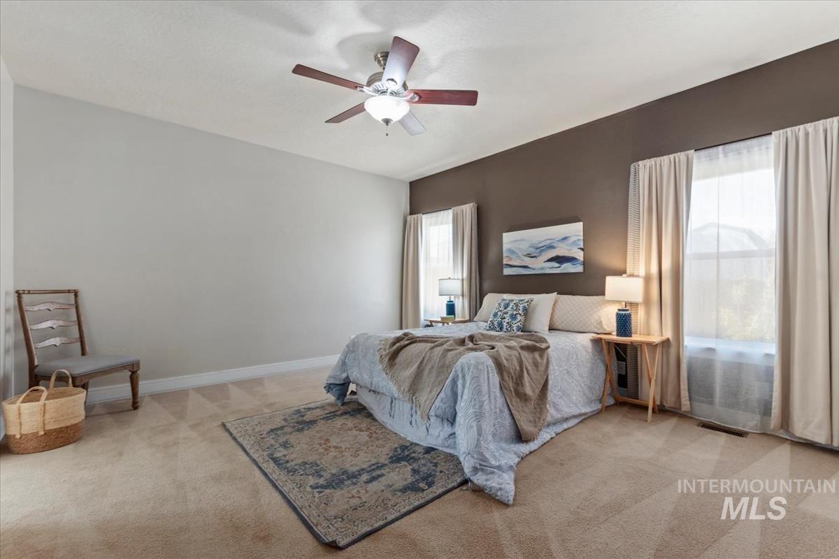 640 Southwest Miner Street Mountain Home, ID 83647 - Photo 16 of 35 Carpeted bedroom featuring a vaulted ceiling and a ceiling fan with light fixture