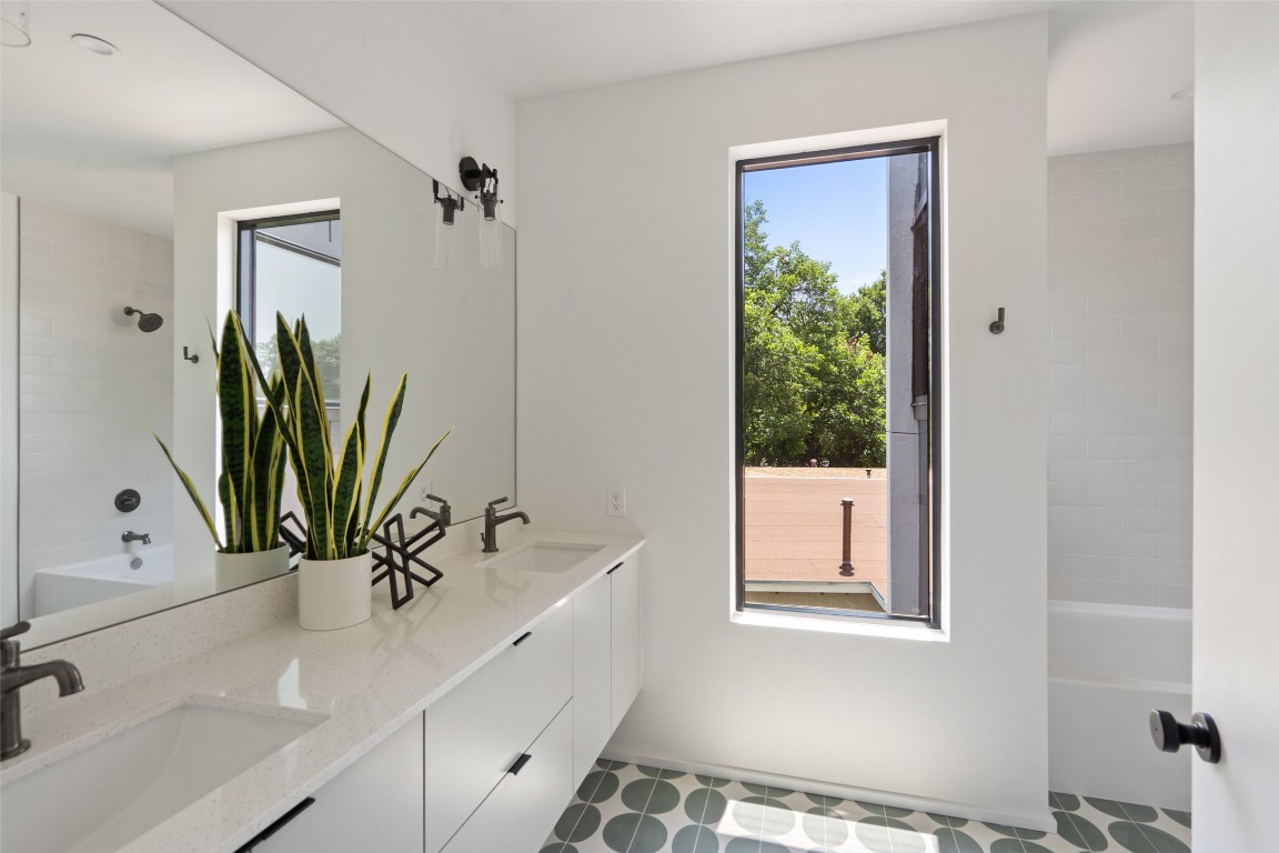 1203 Richcreek Road Austin, TX 78757 - Photo 20 of 28 a bathroom with a bathtub a sink and a window