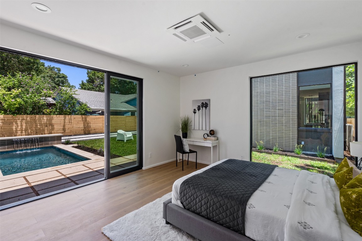 1203 Richcreek Road Austin, TX 78757 - Photo 27 of 28 a bedroom with a bed and large window