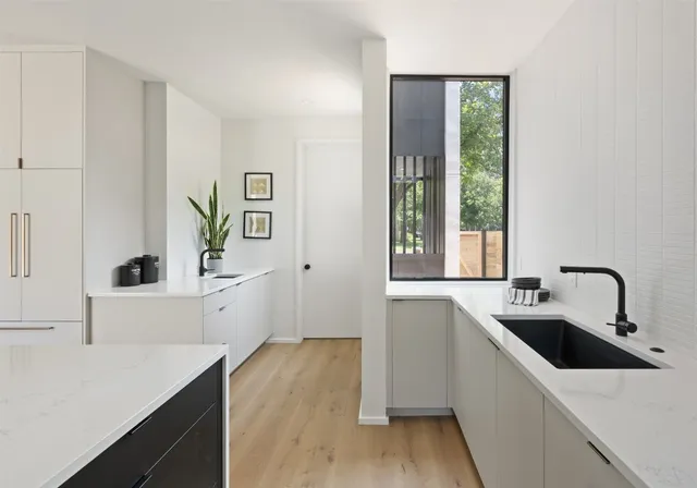 a kitchen with a sink and a stove top oven