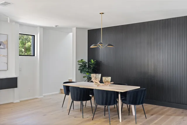 a dining room with furniture and wooden floor