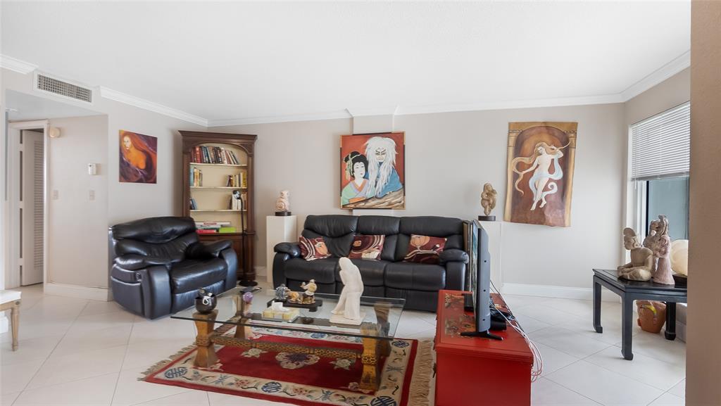 1169 Hillsboro Mile, Unit 717 Hillsboro Beach, FL 33062 - Photo 30 of 37 a living room with furniture a rug and a window