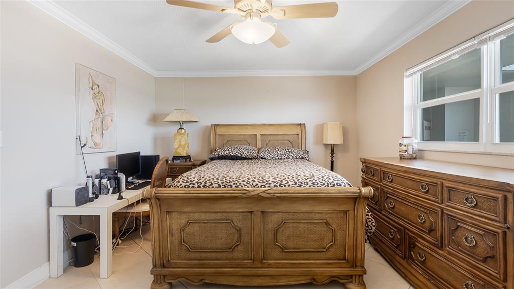 1169 Hillsboro Mile, Unit 717 Hillsboro Beach, FL 33062 - Photo 5 of 37 a bedroom with a bed and a window