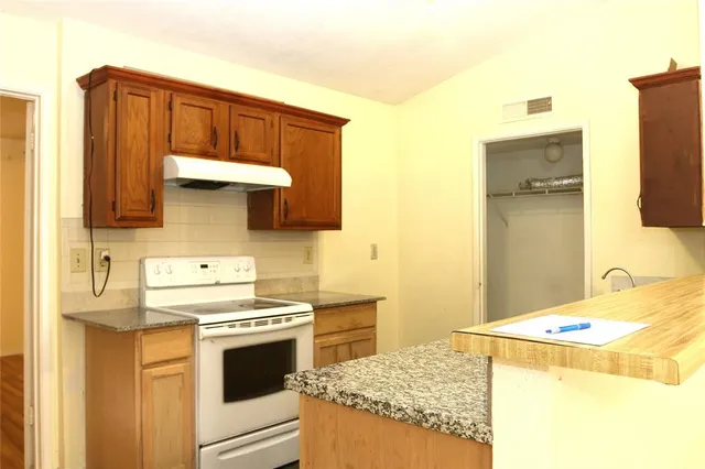 a kitchen with stainless steel appliances a stove and a refrigerator