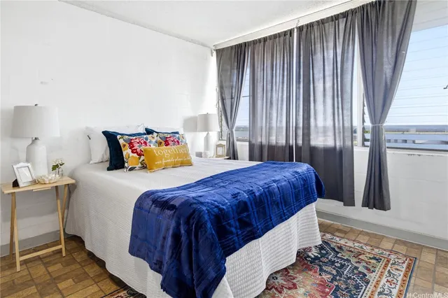 a bedroom with a bed and window