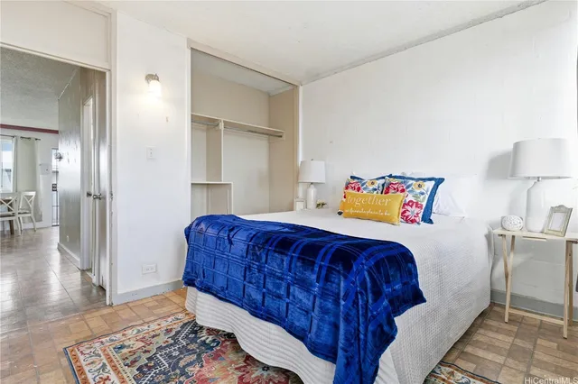 a bedroom with a bed and a lamp