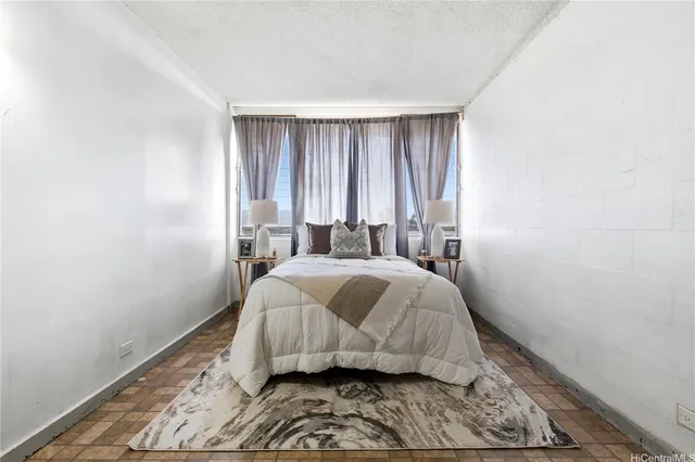 a bedroom with a bed and window