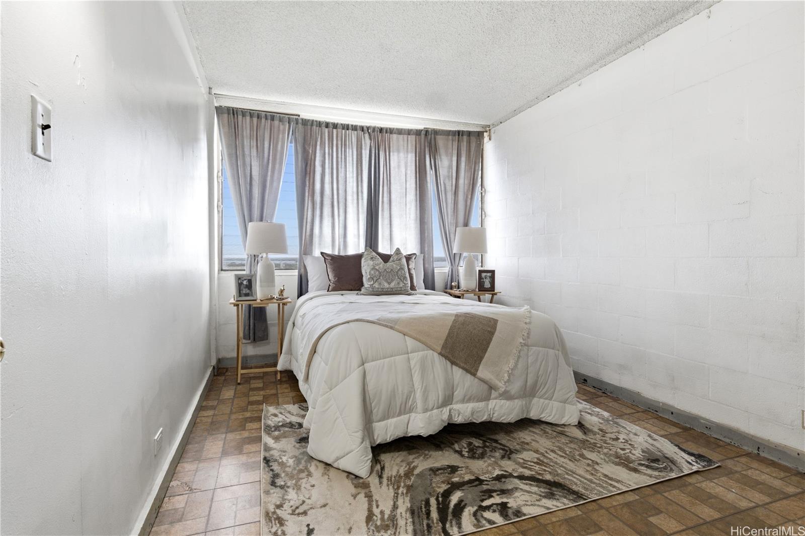 94-249 Waikele Road, Unit B313 Waipahu, HI 96797 - Photo 8 of 13 a bedroom with a bed and wooden floor