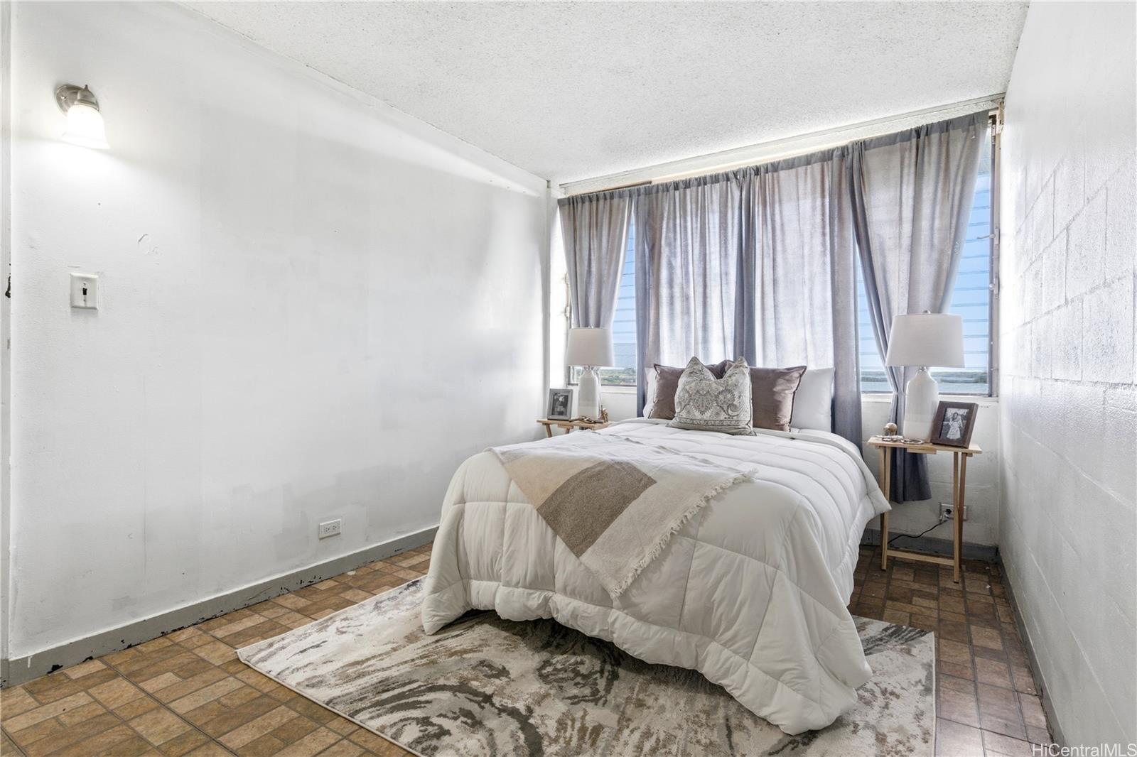 94-249 Waikele Road, Unit B313 Waipahu, HI 96797 - Photo 9 of 13 a bedroom with a bed and a window