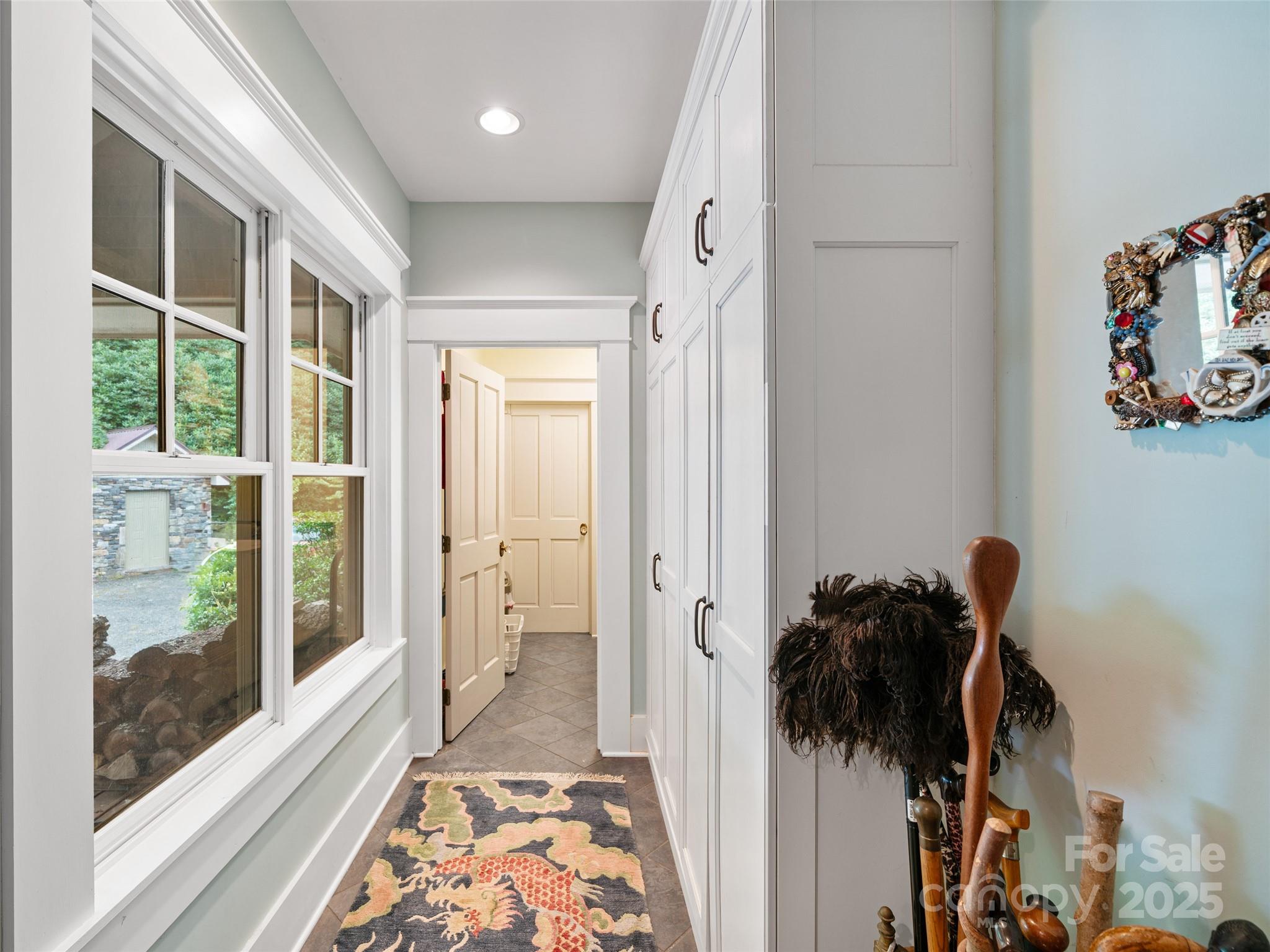 1992 Green Creek Road Bakersville, NC 28705 - Photo 12 of 48 a view of a hallway to a livingroom with wooden floor and a shower