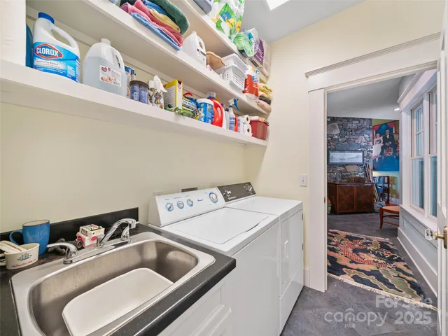 a utility room with sink dryer and washer