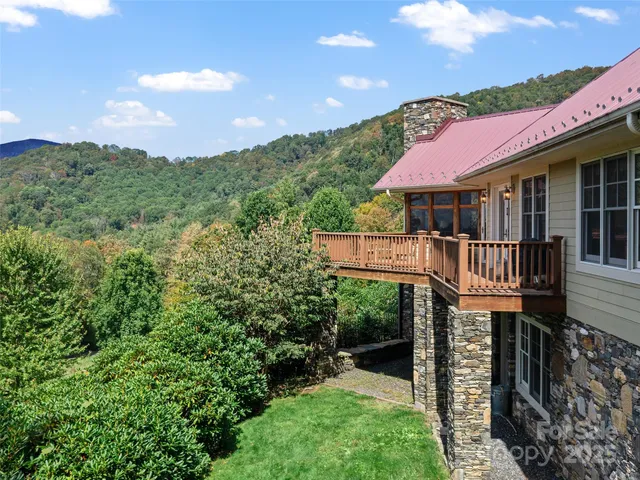 a front view of a house with yard and mountain view