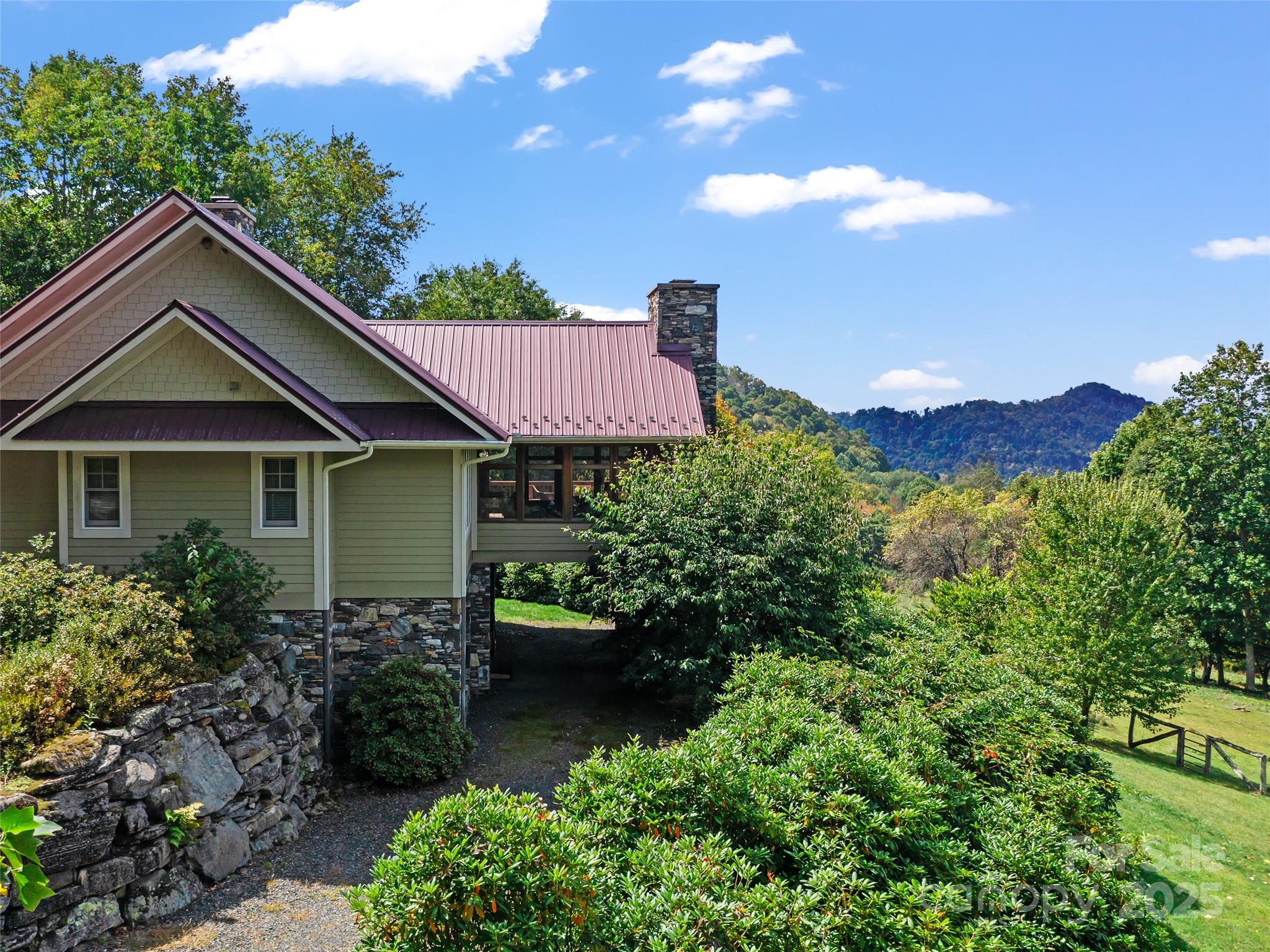 1992 Green Creek Road Bakersville, NC 28705 - Photo 23 of 48 a front view of a house with a yard and garage