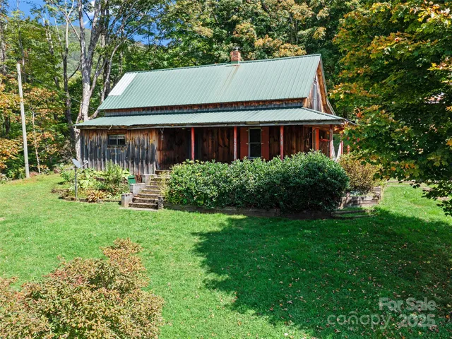 a view of house with yard and green space