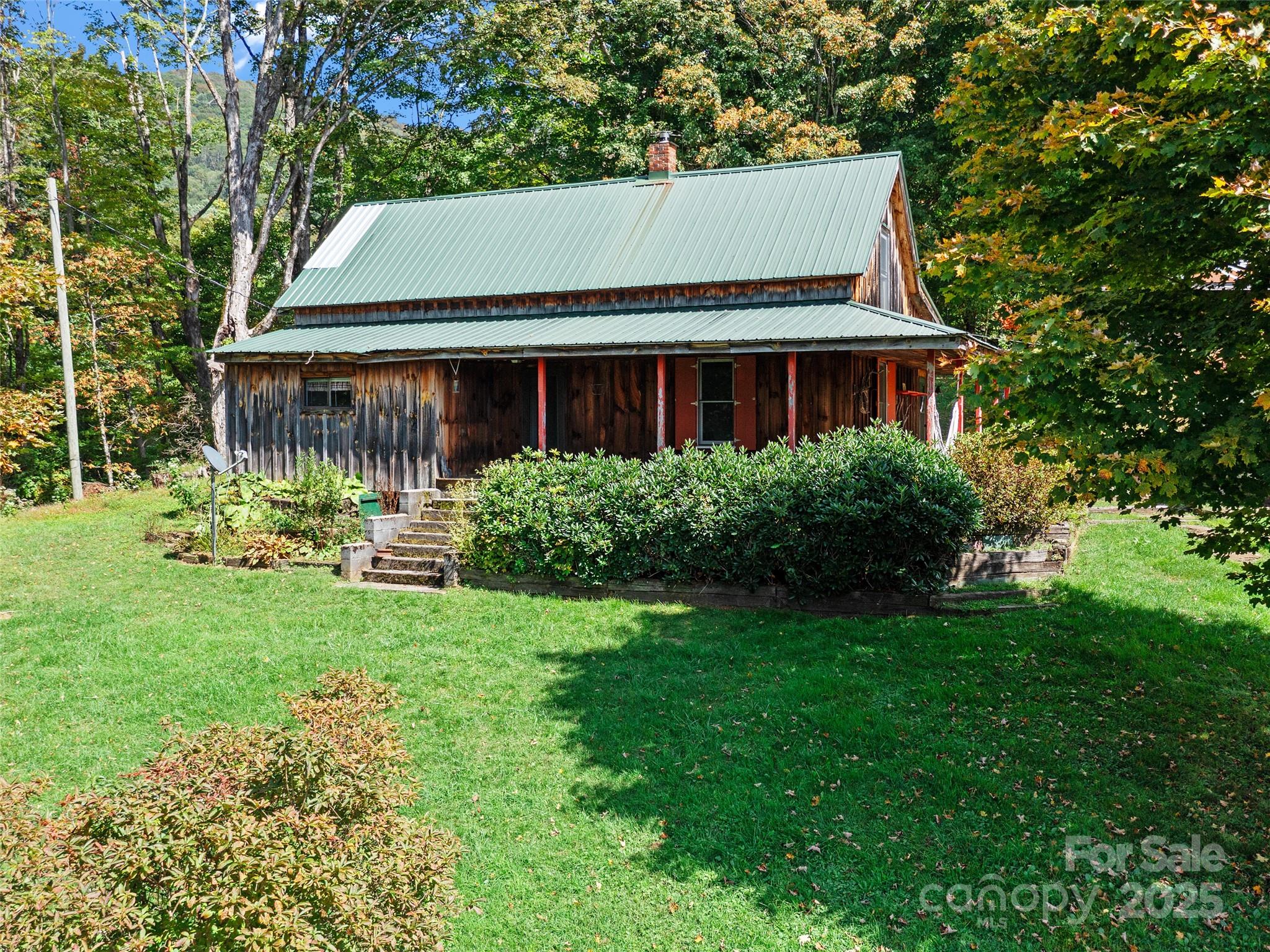 1992 Green Creek Road Bakersville, NC 28705 - Photo 32 of 48 a view of house with yard and green space
