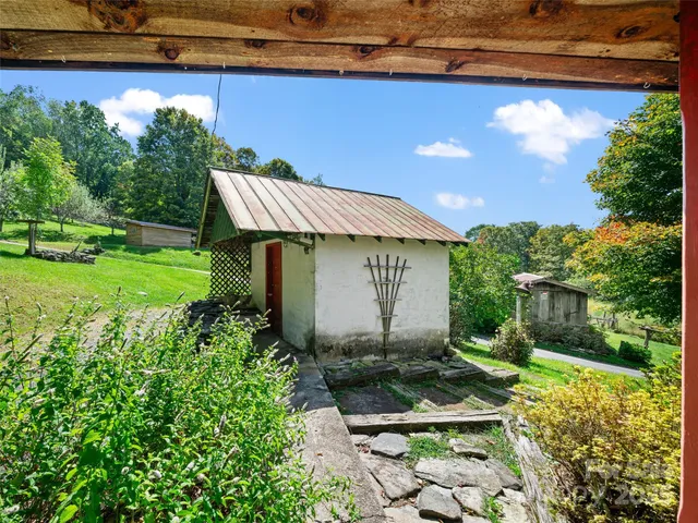 a view of a backyard with plants and a patio