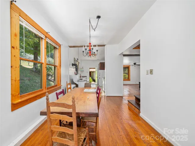a view of a dining room with furniture and a chandelier