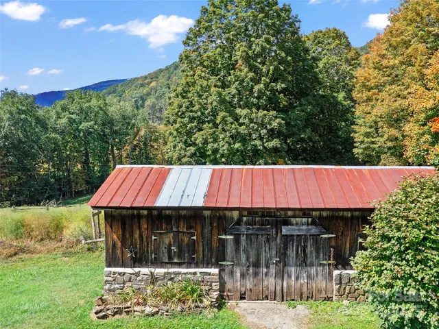 a view of barn with a yard