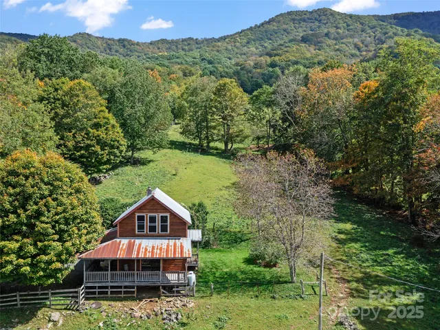 an aerial view of a house next to a yard
