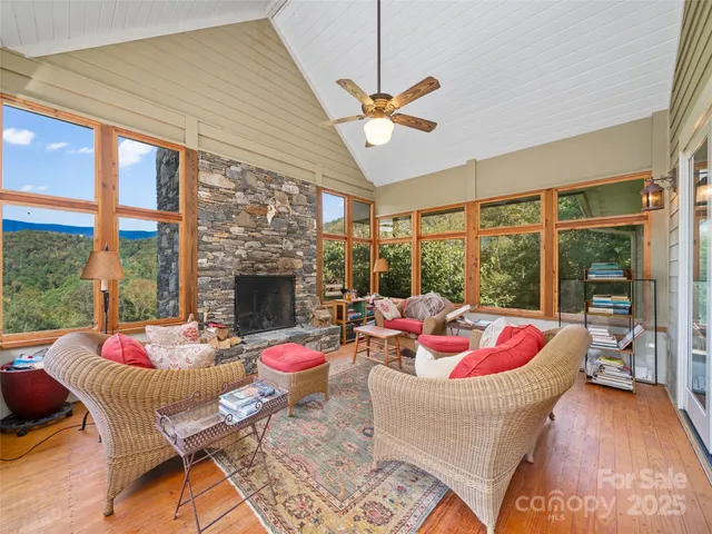 a living room with furniture and a floor to ceiling window