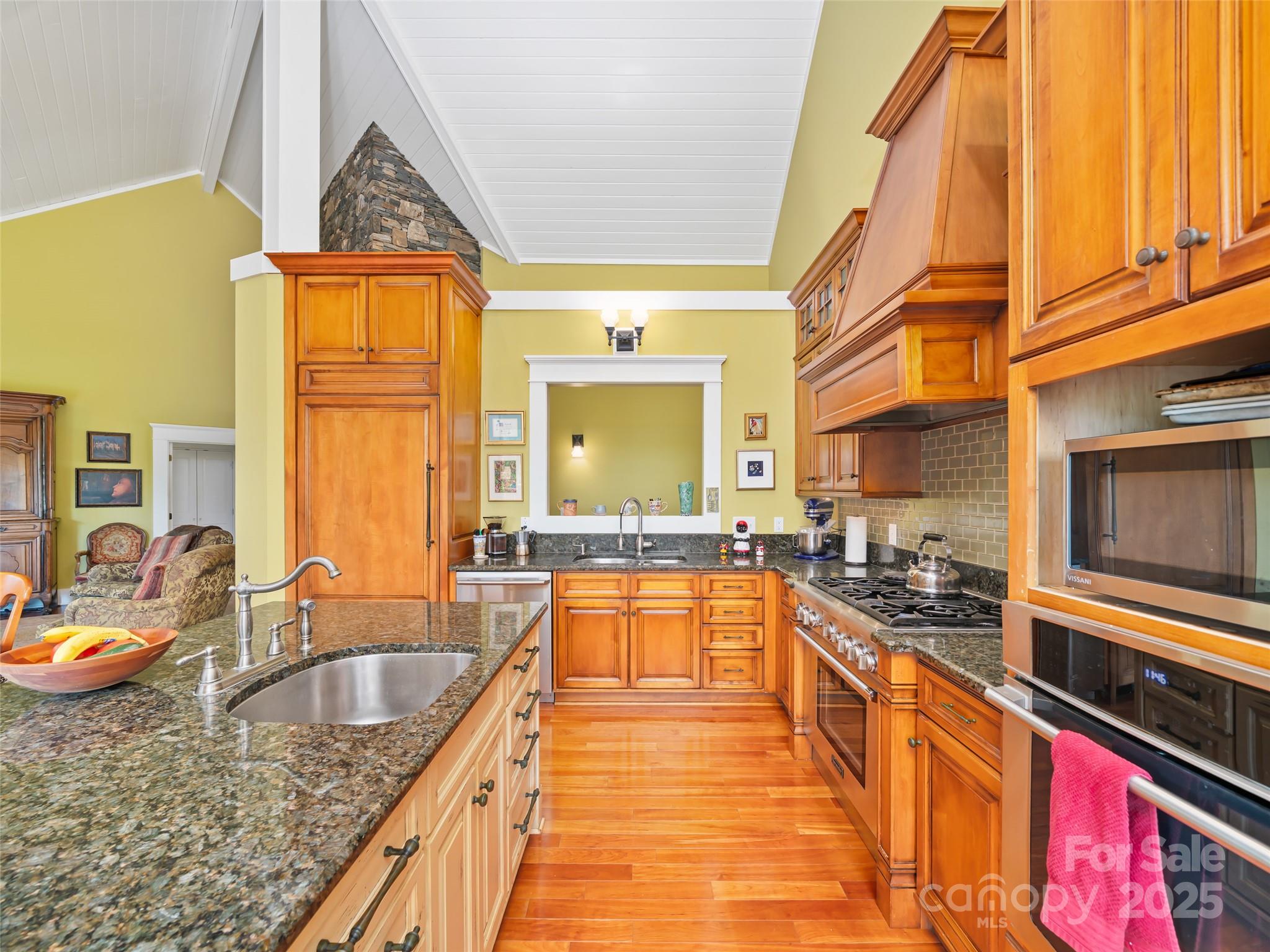 1992 Green Creek Road Bakersville, NC 28705 - Photo 10 of 48 a kitchen with stainless steel appliances granite countertop a sink a stove and a wooden cabinets