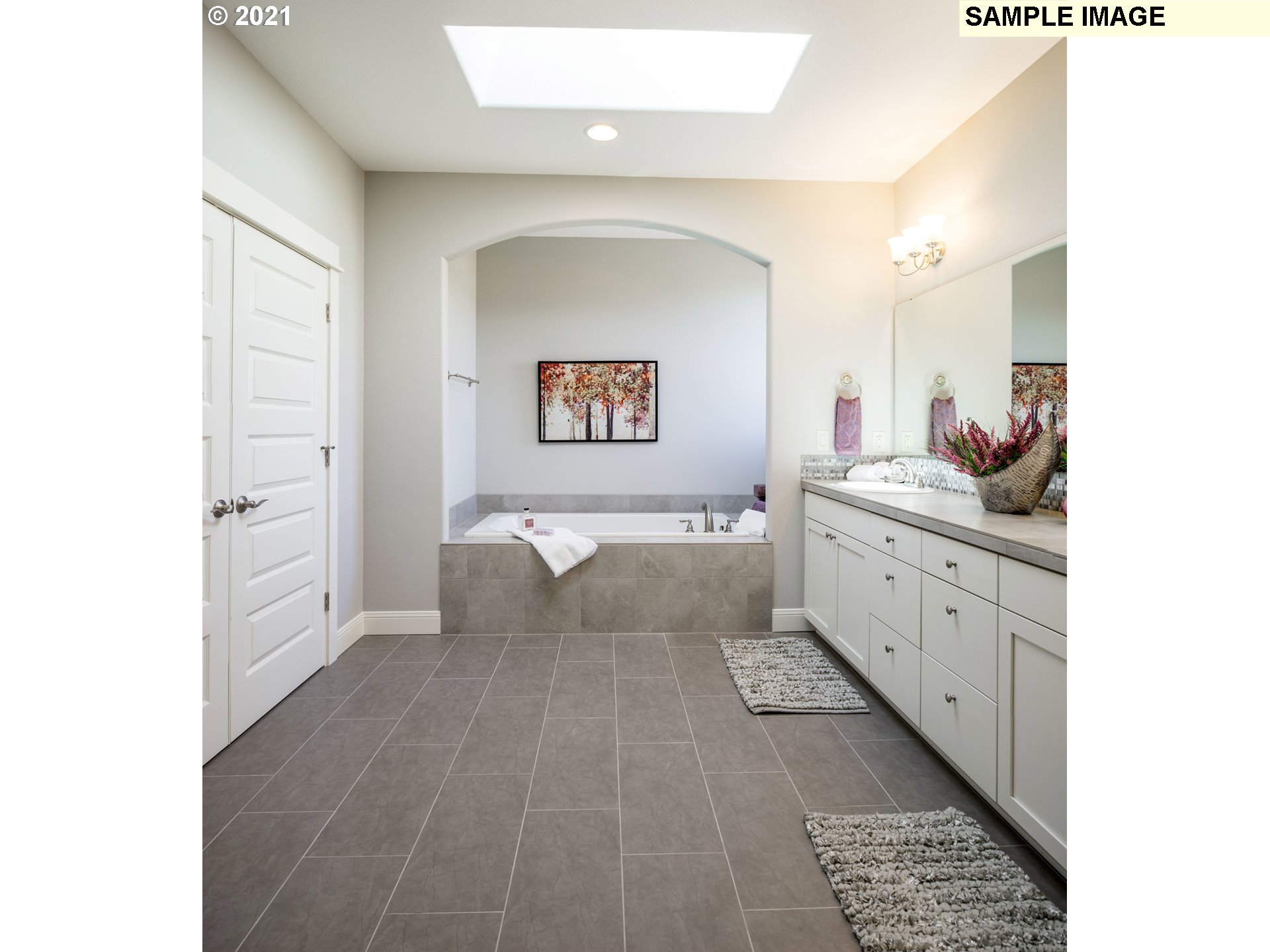 2938 South Cherry Grove Way Ridgefield, WA 98642 - Photo 18 of 20 a spacious bathroom with a double vanity sink a mirror and a bathtub