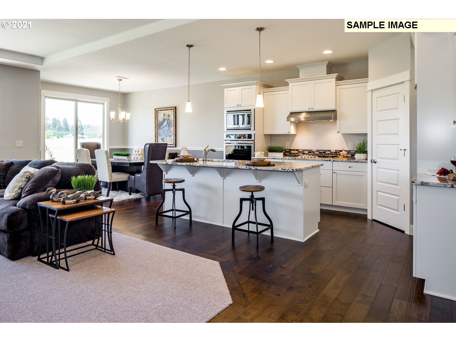 2938 South Cherry Grove Way Ridgefield, WA 98642 - Photo 7 of 20 a kitchen with stainless steel appliances granite countertop a stove a refrigerator a kitchen island a dining table and chairs with wooden floor