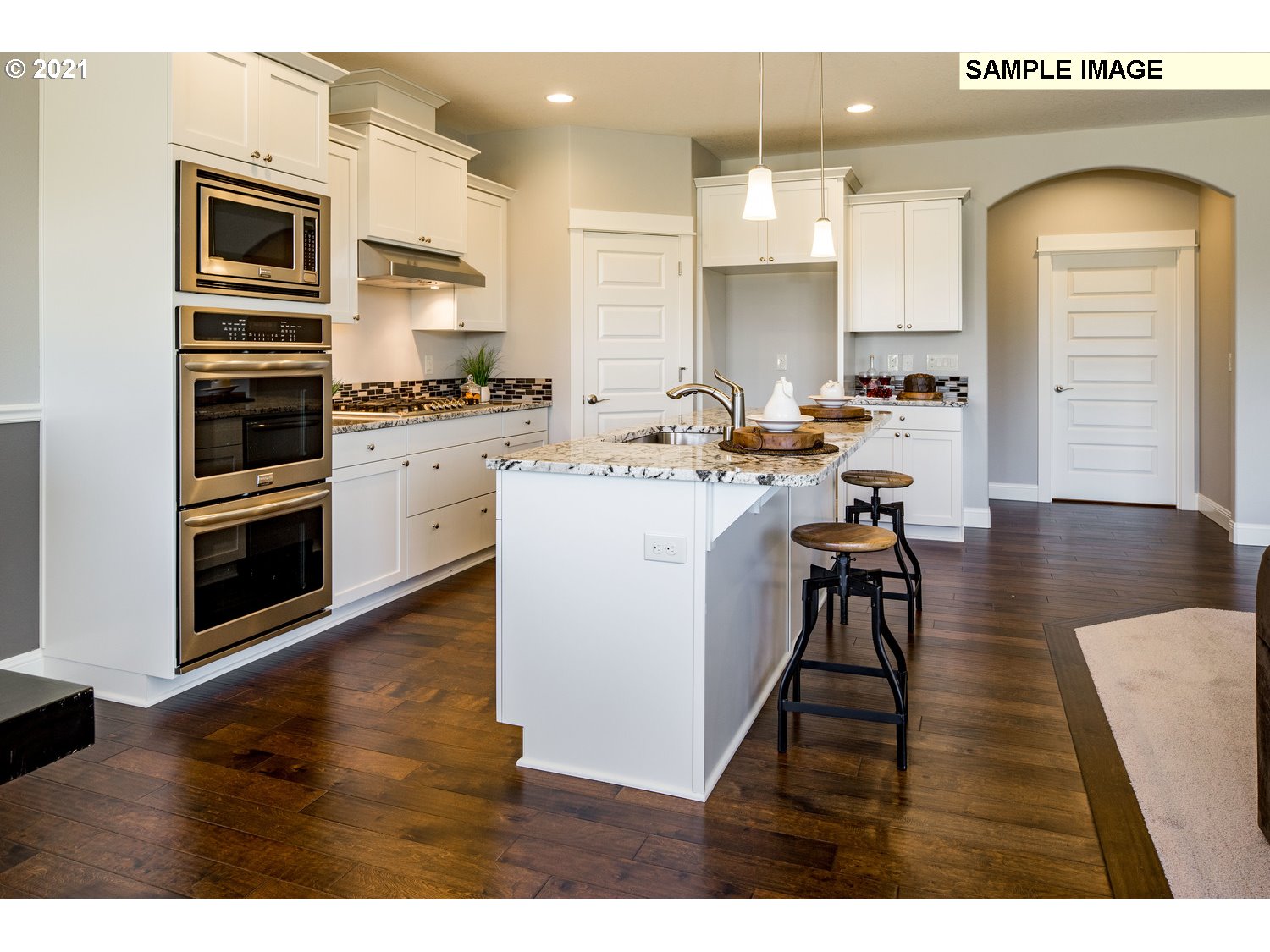 2938 South Cherry Grove Way Ridgefield, WA 98642 - Photo 9 of 20 a kitchen with sink refrigerator and cabinets