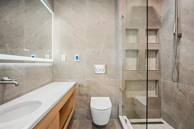 a bathroom with a toilet and a shower