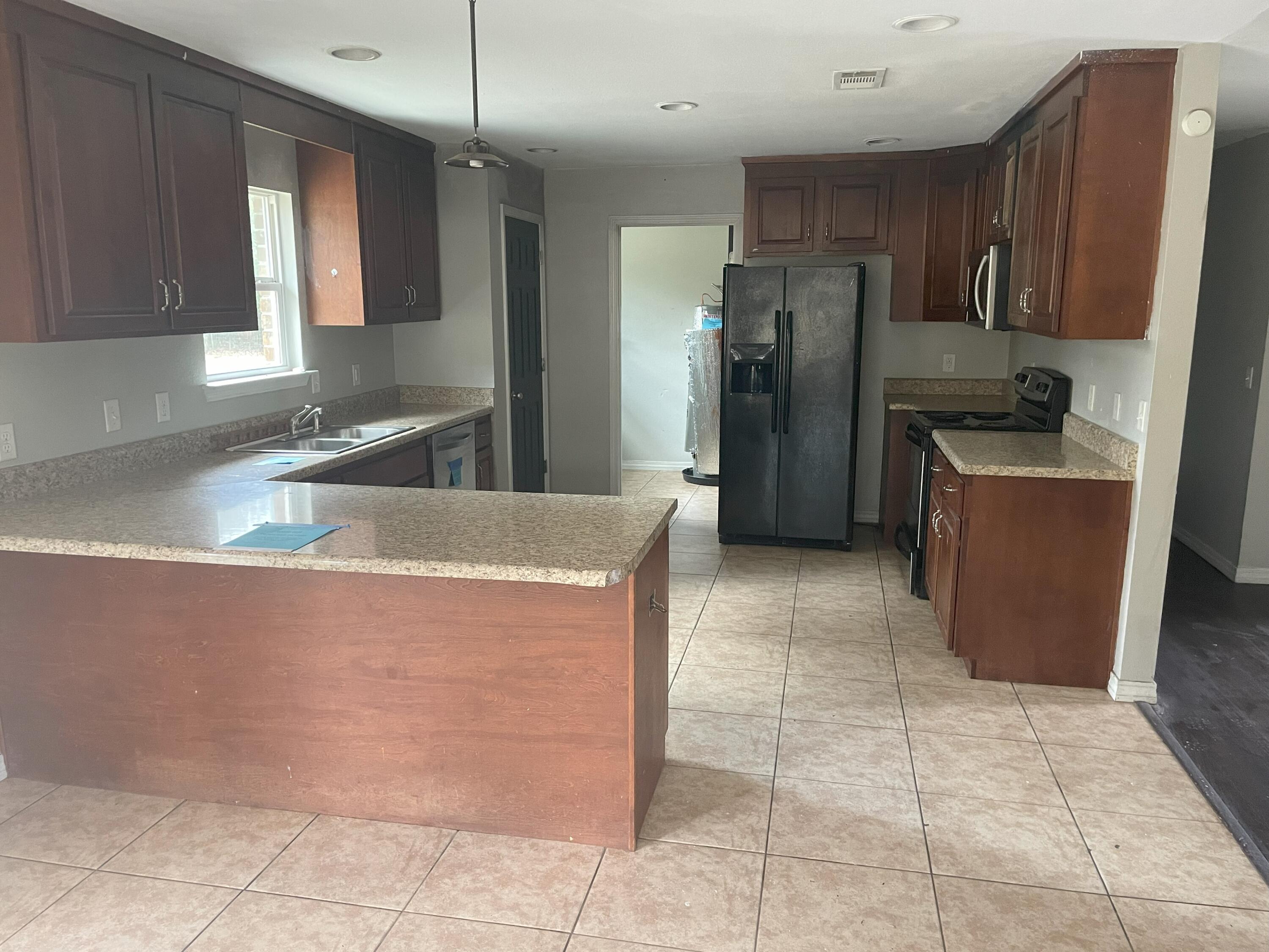 4052 Randi Road Crestview, FL 32539 - Photo 8 of 27 a kitchen with stainless steel appliances granite countertop a refrigerator and a sink